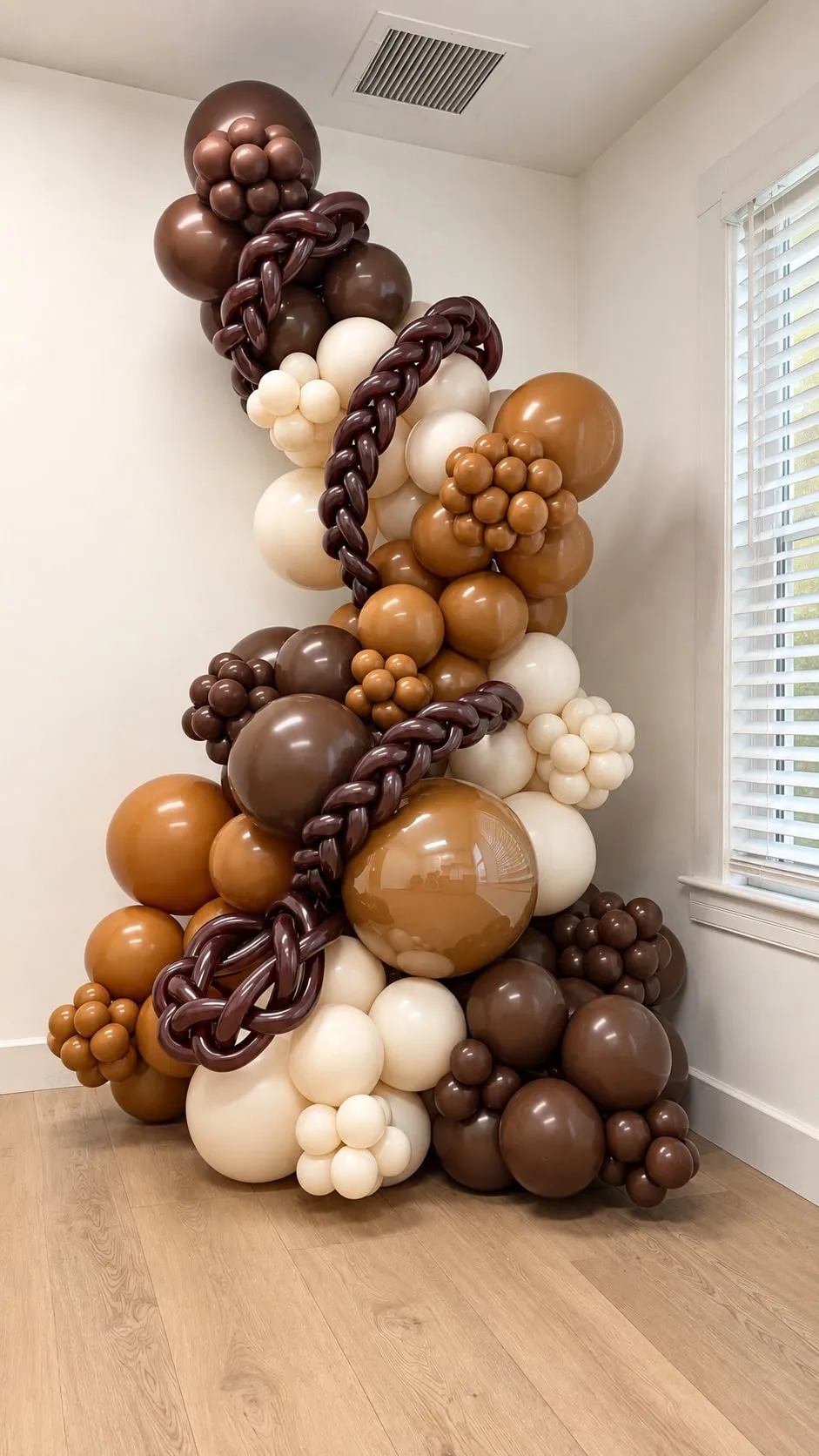 Tall organic balloon garland in brown, caramel and cream with braided accents