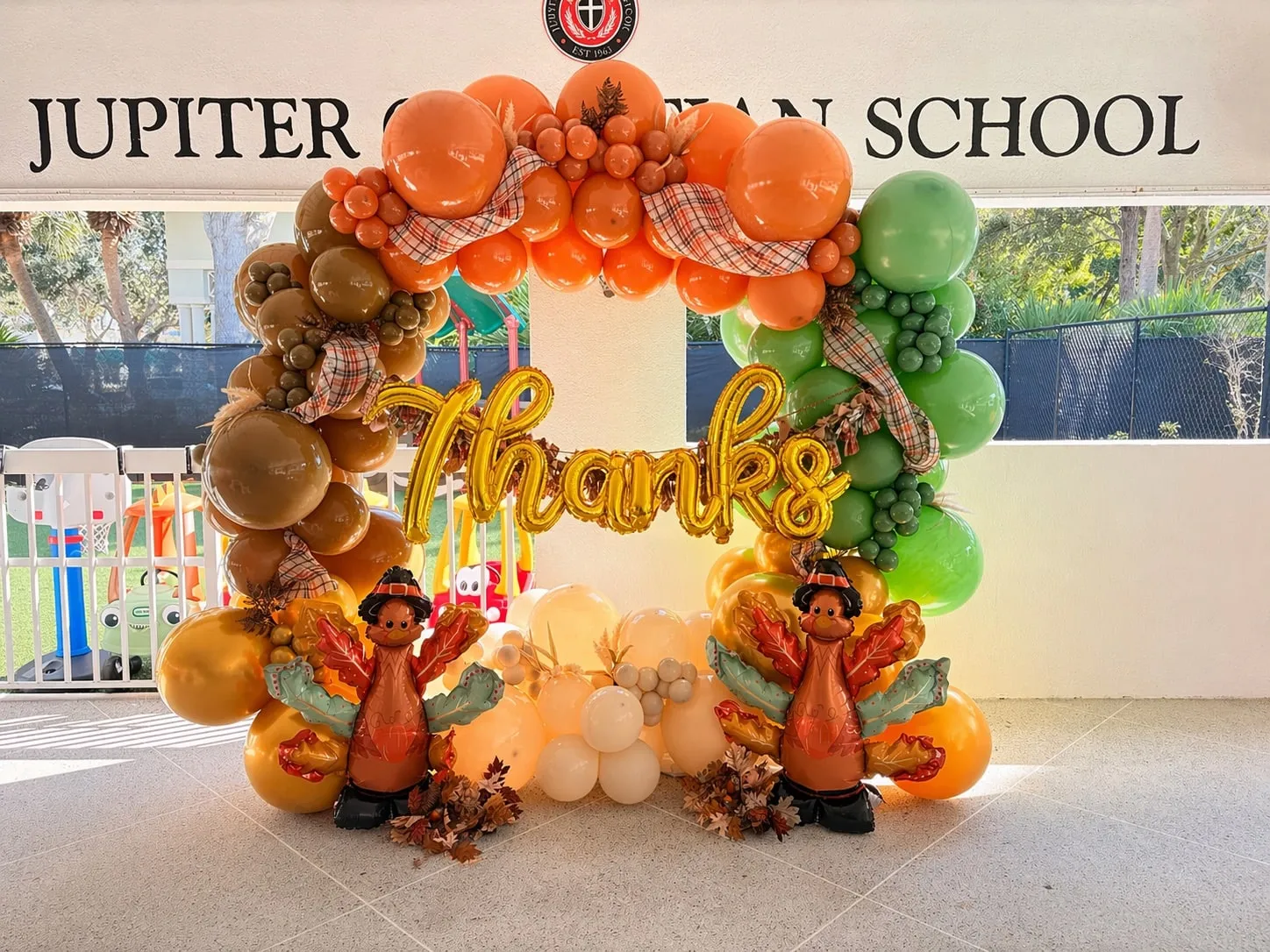 Balloon photo frame in orange, brown and green with plaid ribbon, gold script and two turkey balloons